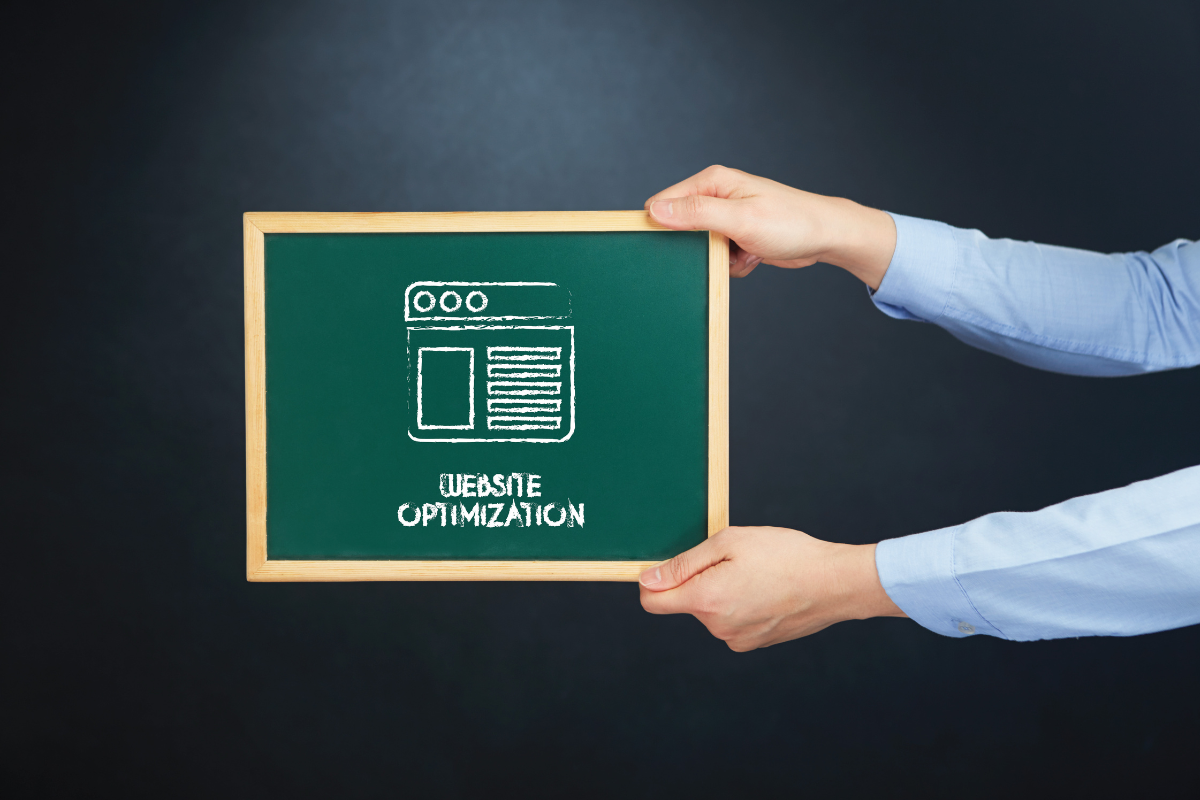 Optimized Websites: Unveiling The Secrets To Superior Online Performance 2 A man holding up a chalkboard with the word "website optimization."