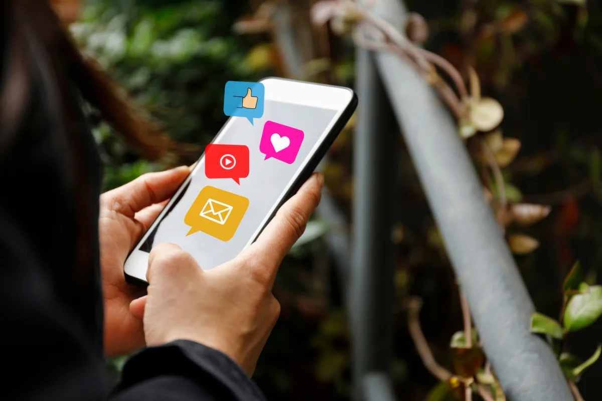 Social Media Copy: Master the Art of Writing Engaging Online Content 4 a phone with social media icons on it
