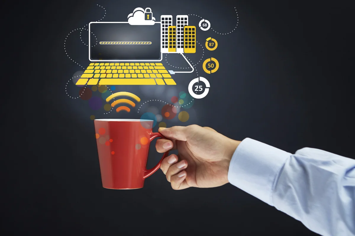 WordPress Website Migration Checklist For A Seamless Transition 6 A hand holding a red mug with a laptop on top.