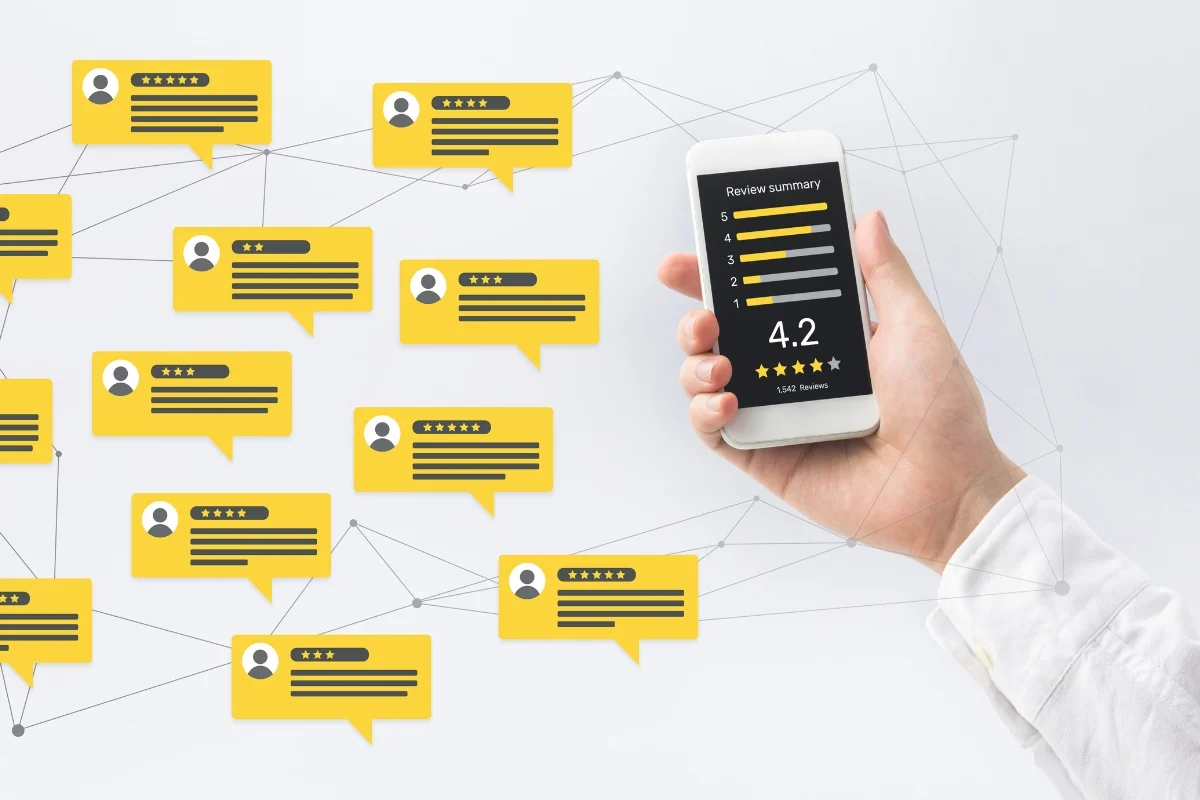Hand holding a smartphone displaying a review summary from Google Maps, surrounded by chat bubble icons with star ratings on a white background.