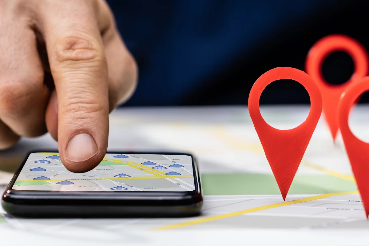 Location Pages: Maximizing Local SEO For Your Business Success 6 A person pointing at a local search on a cell phone.