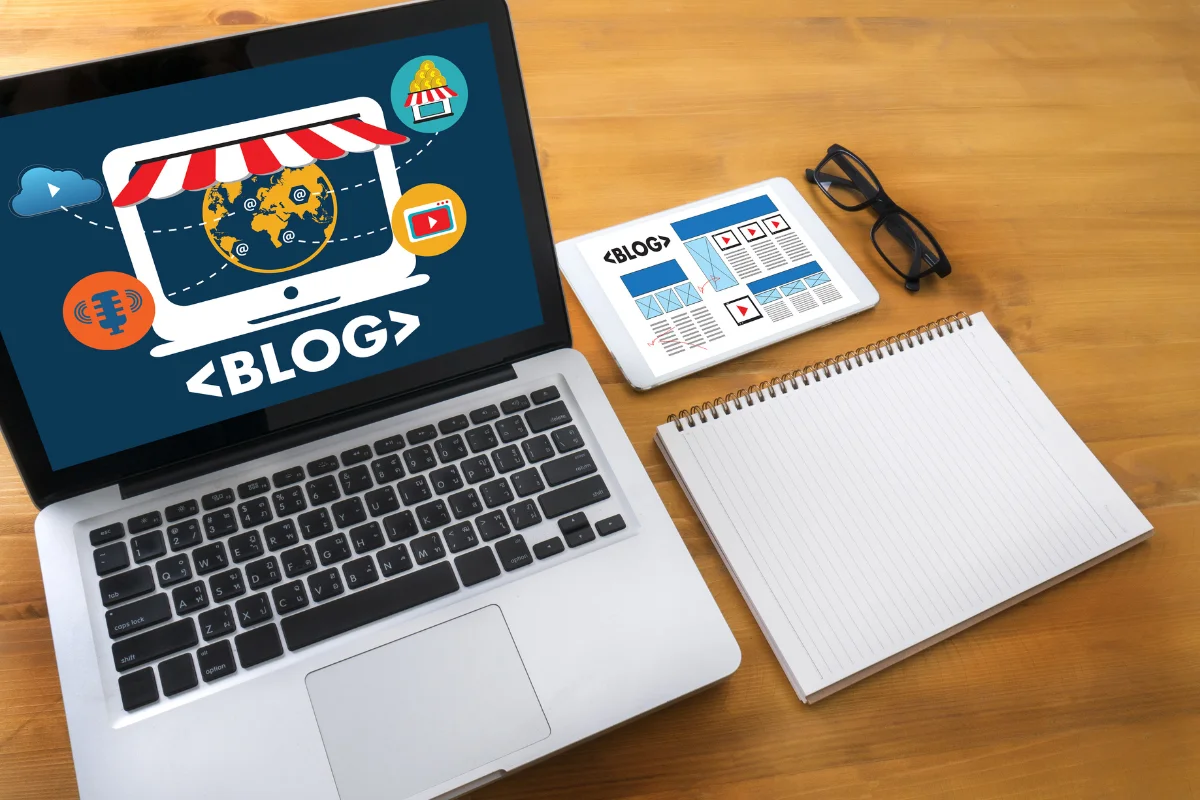 We Write Blog Posts: Crafting Compelling Content For Success 6 A laptop with the word "blog" on it for "we write blog posts" next to a tablet and phone.