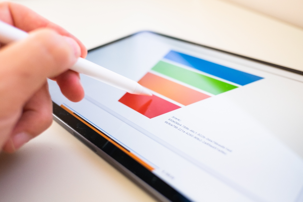 What is a Sales Funnel: Unlocking the Key to Sales Success 3 A person holding a pen on an iPad, illustrating what is a sales funnel on it.