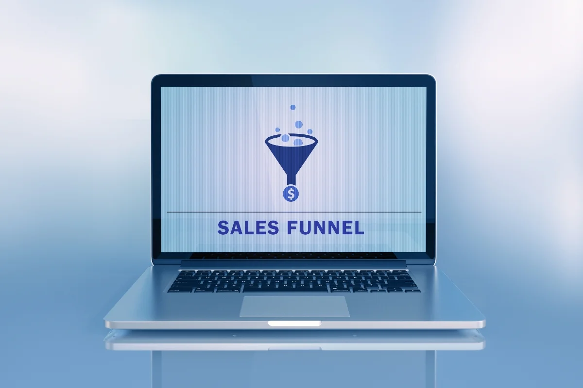 A laptop screen displaying the words "What is a sales funnel?