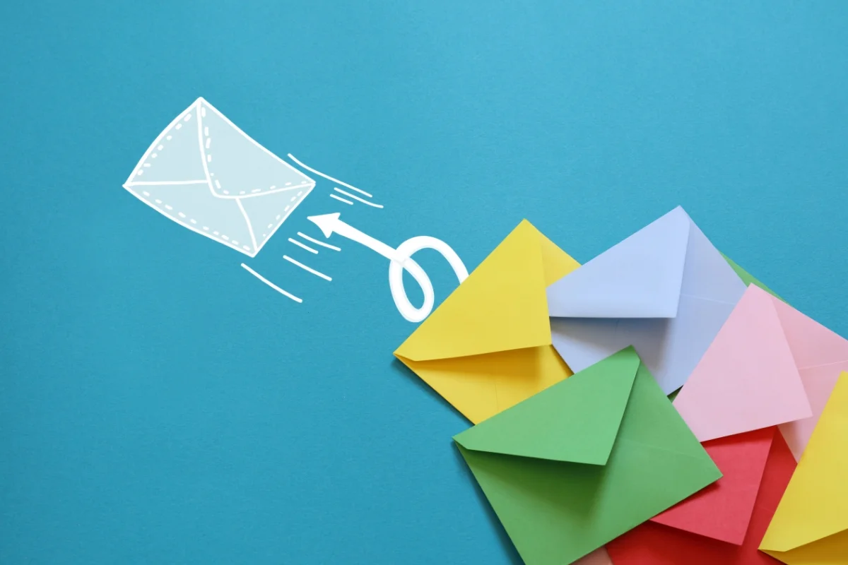 Email Targeting: Master the Art of Personalized Messaging 3 Colorful paper envelopes with a white arrow and envelope illustration on a blue background, reminiscent of email targeting.