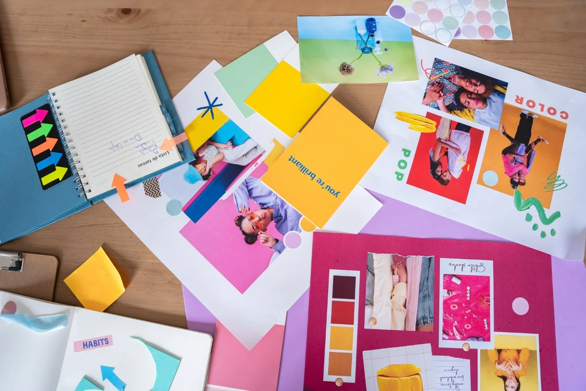 What Is Hyperlocal Marketing: Targeting for Local Business Growth 7 A cluttered desk with colorful mood boards, notebooks, sticky notes titled "What Is Hyperlocal Marketing," and various art supplies scattered around.