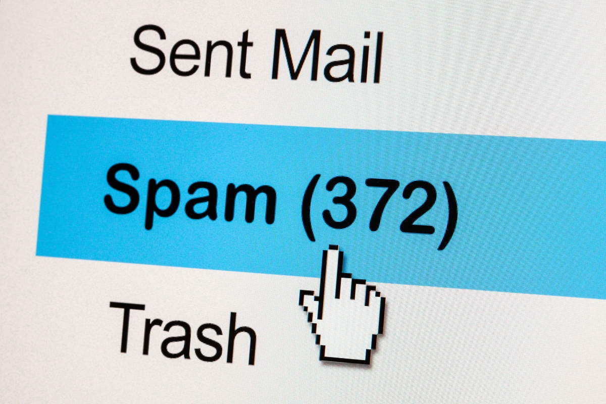Computer screen showing an email inbox with the Spam folder highlighted, displaying 372 spam emails, and a cursor pointing at it—reminding users of the importance of must-have plugins for effective spam control.