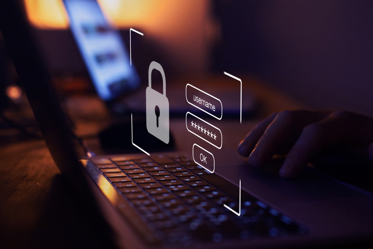 A person types on a laptop keyboard with a digital login interface overlay showing a padlock, username, password, and OK button—highlighting the importance of must-have plugins for secure access.