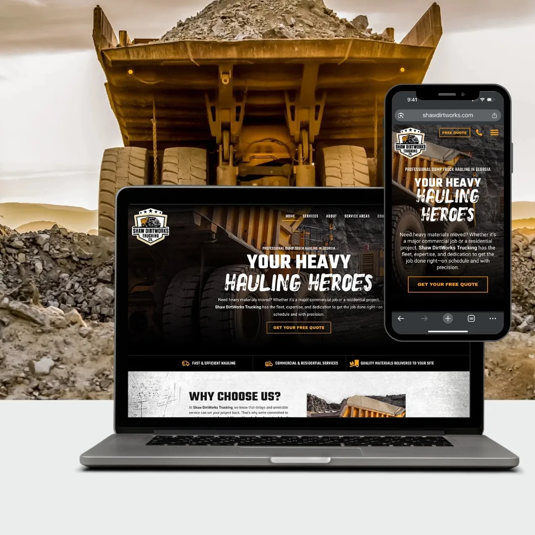 A laptop and smartphone display Shaw DirtWorks' website, a leading trucking and heavy equipment hauling company, with a large dump truck filled with rocks in the background.